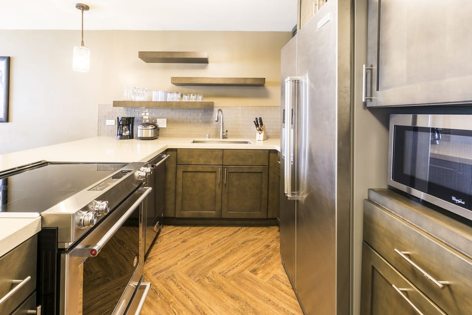 Your fully-equipped kitchen features sleek stainless appliances, ample counter space, and modern cabinetry—perfect for preparing home-cooked meals during your getaway.