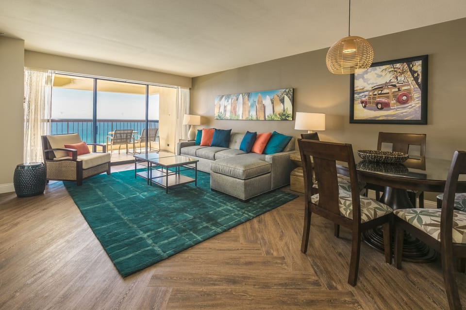 Picture yourself unwinding here with ocean breezes through your balcony doors. This bright, beachy living space flows seamlessly to your dining area, creating the perfect beach getaway retreat.