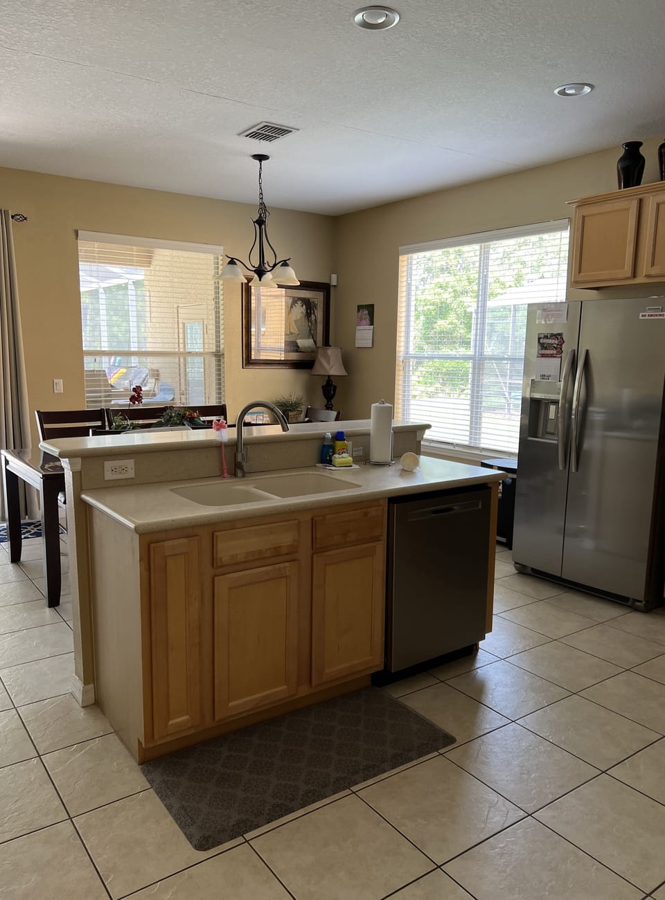 Kitchen with island sink and attached dishwasher. 