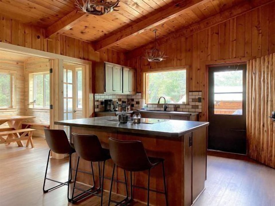 Spacious kitchen with breakfast bar and modern appliances.