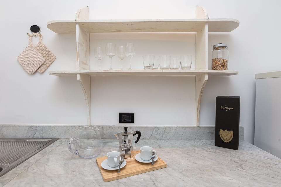 Fully equipped kitchen with cooking utensils and cutlery.
