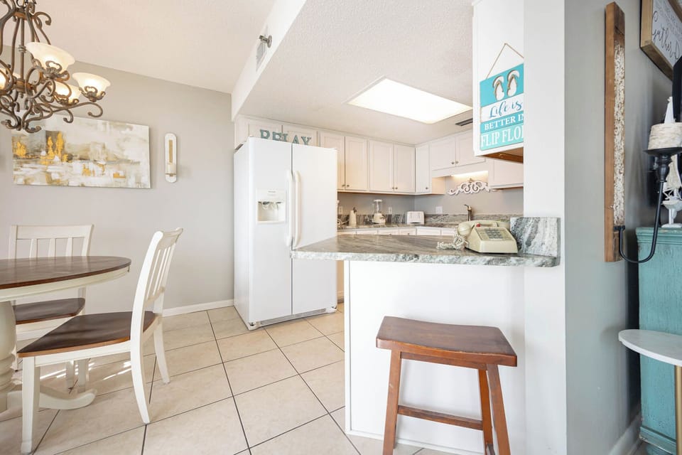 Gather around the round table under a chandelier, enjoying meals while admiring the stylish decor and open layout