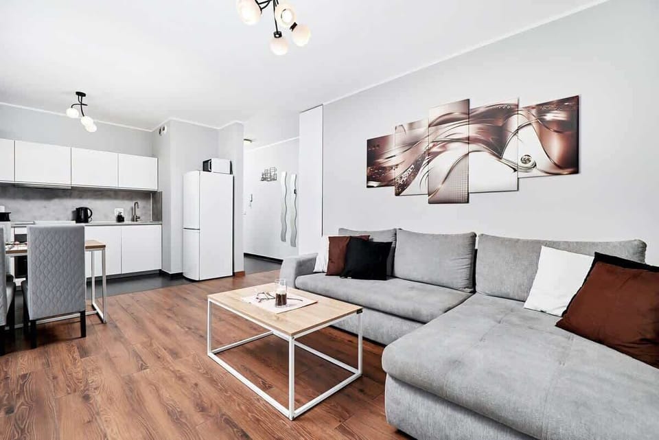 The elegant living room featuring a double sofa bed, perfect for relaxing or sleeping.