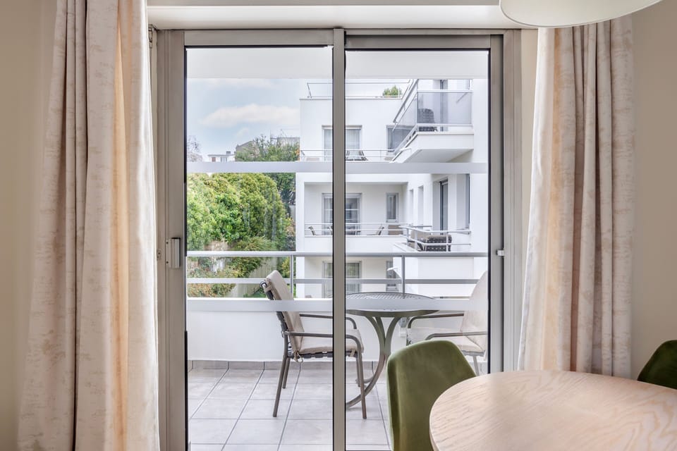 Step out onto the private balcony and enjoy the scenic views of the surrounding greenery.