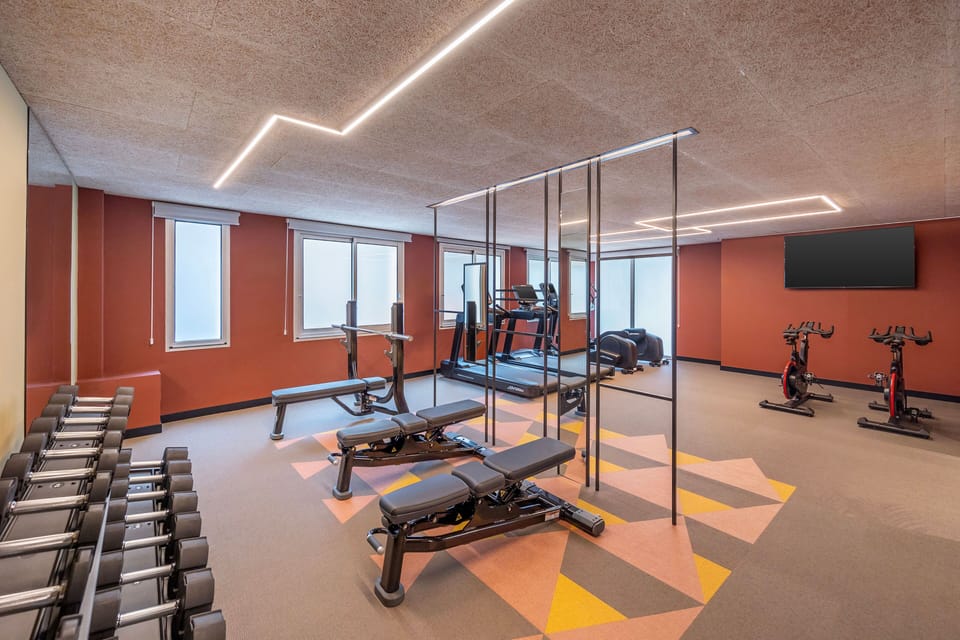 A bright and spacious gym with state-of-the-art equipment and plenty of room to exercise.