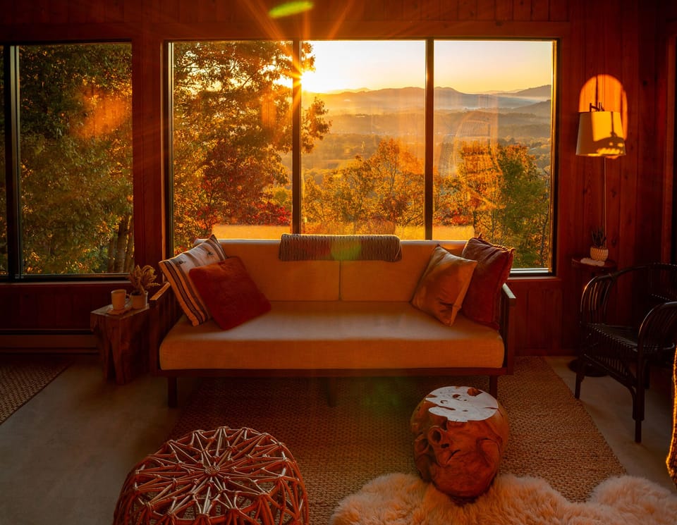 The sunrise over the mountains floods the sunroom with beautiful, moody light.