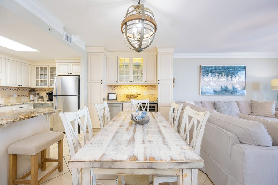 Rustic dining table invites laughter and stories as you gaze out toward the sparkling gulf coast beyond your balcony