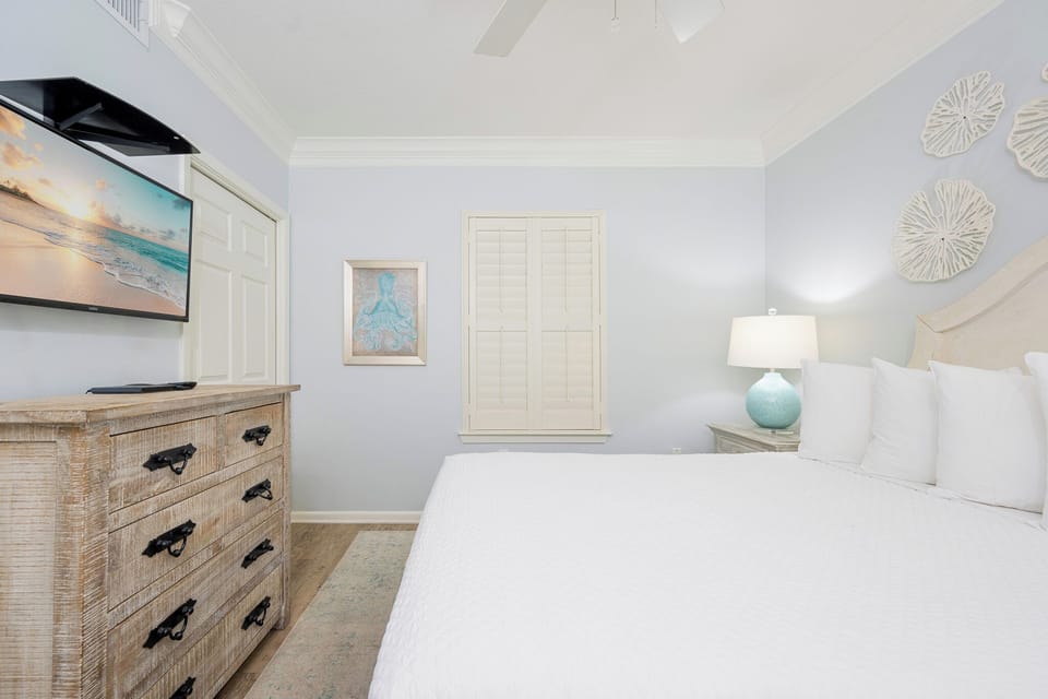 Pillows arranged for rest await in the guest suite with a TV ready for your favorite show
