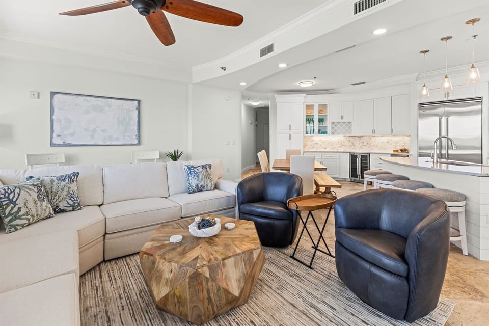 Unwind in your open-concept living space where coastal charm meets modern comfort, with plush seating and a chef's kitchen ready for memorable moments.