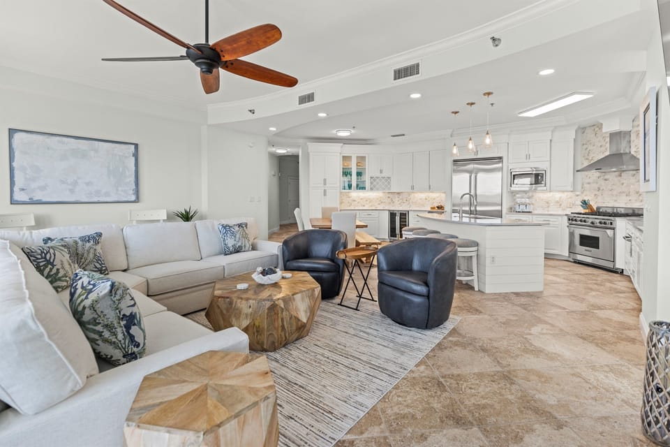 Your stylish open-concept living space features comfortable seating, modern kitchen, and coastal-inspired décor for relaxing vacation moments.