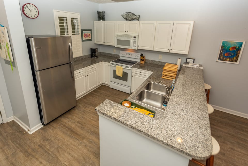 Kitchen is equipped with appliances, coffee maker, plates/utensils, etc.
