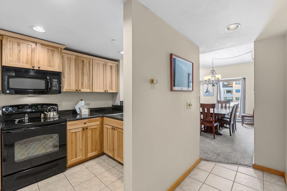 Your fully equipped kitchen opens to a bright dining space, ready for easy meal prep and relaxed gatherings with loved ones.