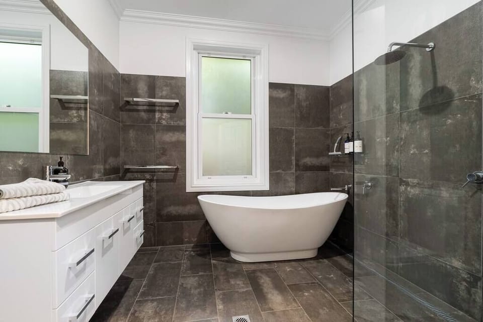 Main bathroom with free standing bath & shower with large vanity & toilet