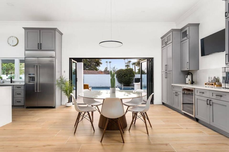 tart your day with sunlight and pool views in this bright kitchen with an easy indoor-outdoor flow.