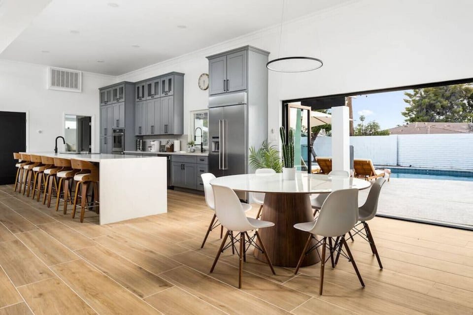 Cook, dine, and hang out in this spacious modern kitchen with a huge island and pool views.