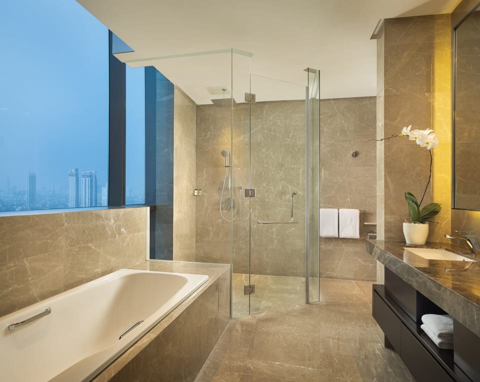 Separate tub and shower, rainfall showerhead, bathrobes, slippers