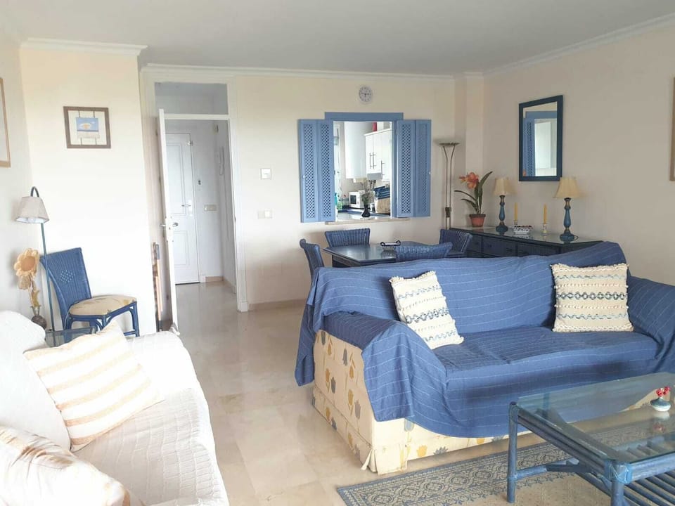 Spacious sitting and dining room with views to the sea and swimming pool