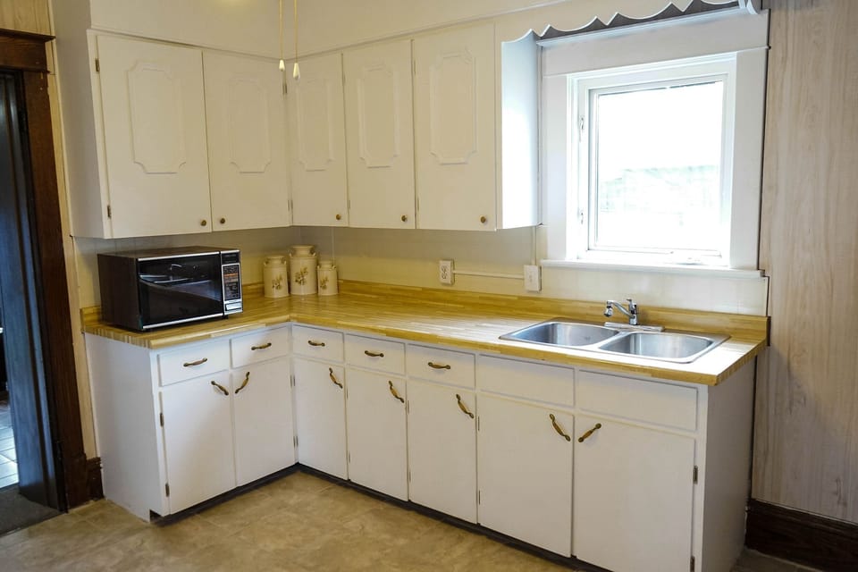Kitchen area-equipped with toaster, microwave kettle, coffee maker, cooking ware