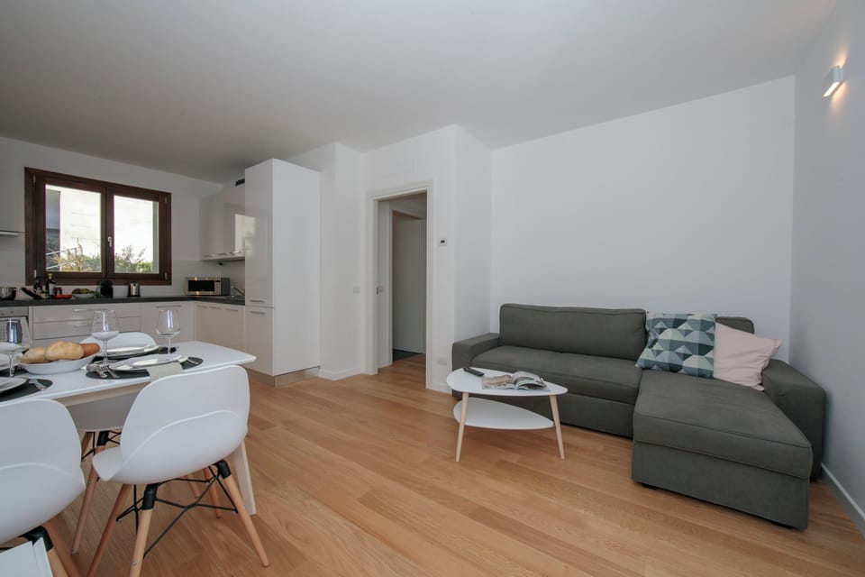 Family Apartment, 2 Bedrooms, Balcony, Mountainside (Argegno Home) | Living area | 24-inch flat-screen TV with digital channels, TV, heated floors