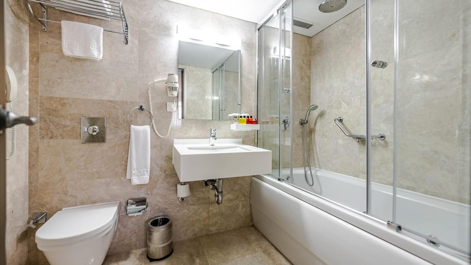 Family Room | Bathroom | Designer toiletries, hair dryer, slippers, bidet