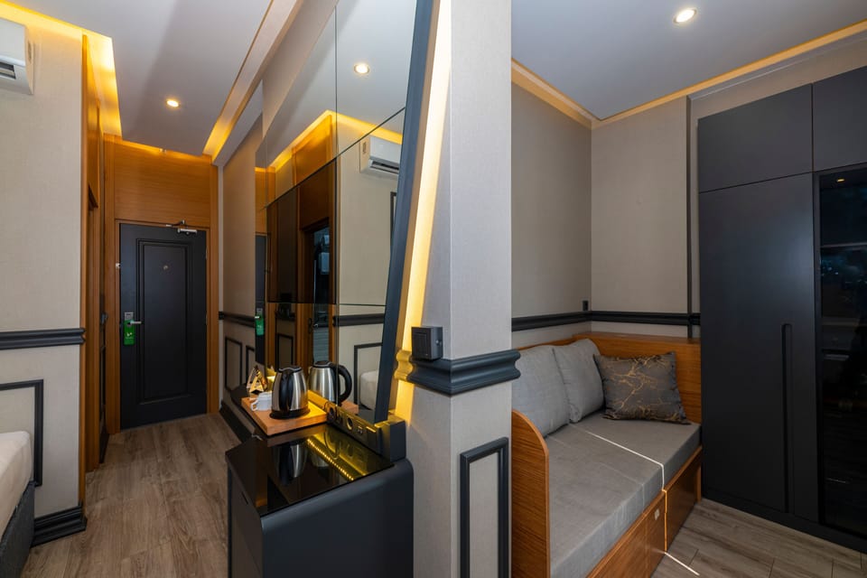 Deluxe Triple Room | Living area | 82-cm LCD TV with satellite channels, TV