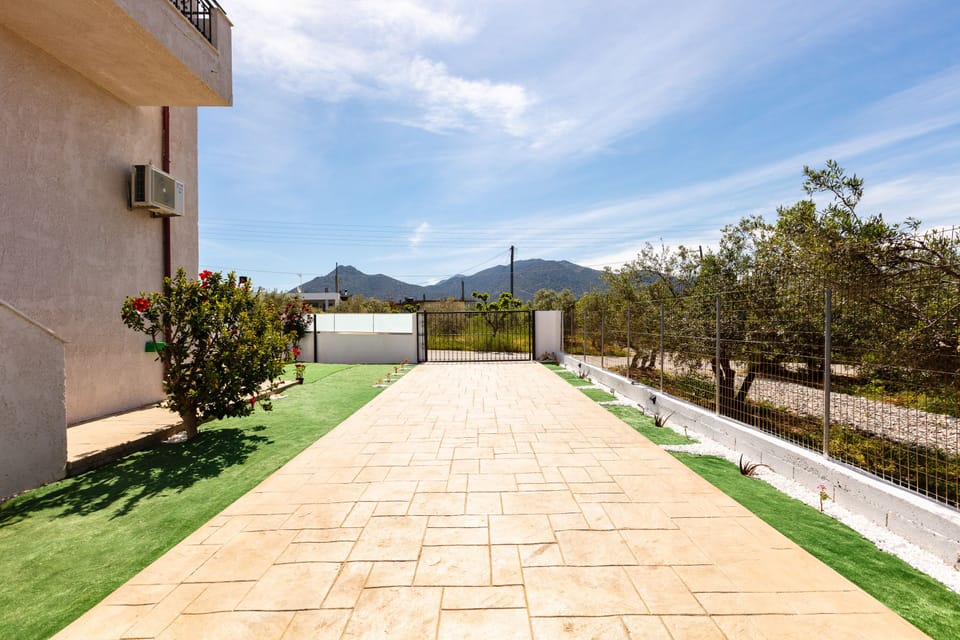 Car entrance of the residence with cream tiles