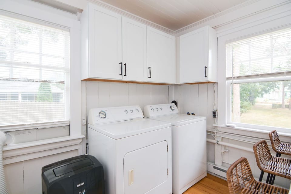 Laundry machines are conveniently tucked into the corner of the kitchen.