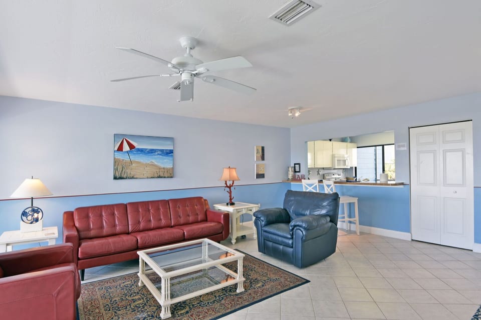 Comfortable living area with sofa seating and Gulf views
