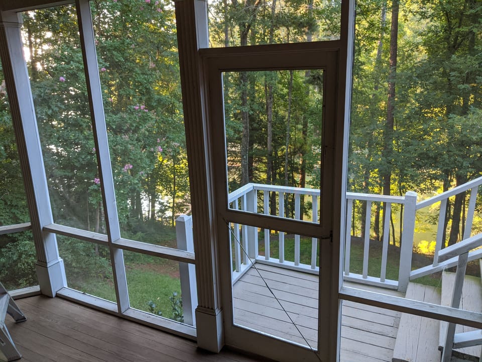 View out of the attached screened porch looking down at the docks.