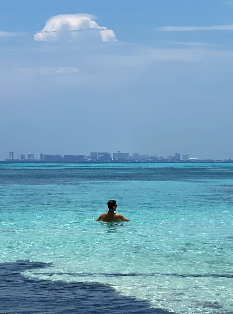Swimming at the secluded beach! View of Cancun skyline.
