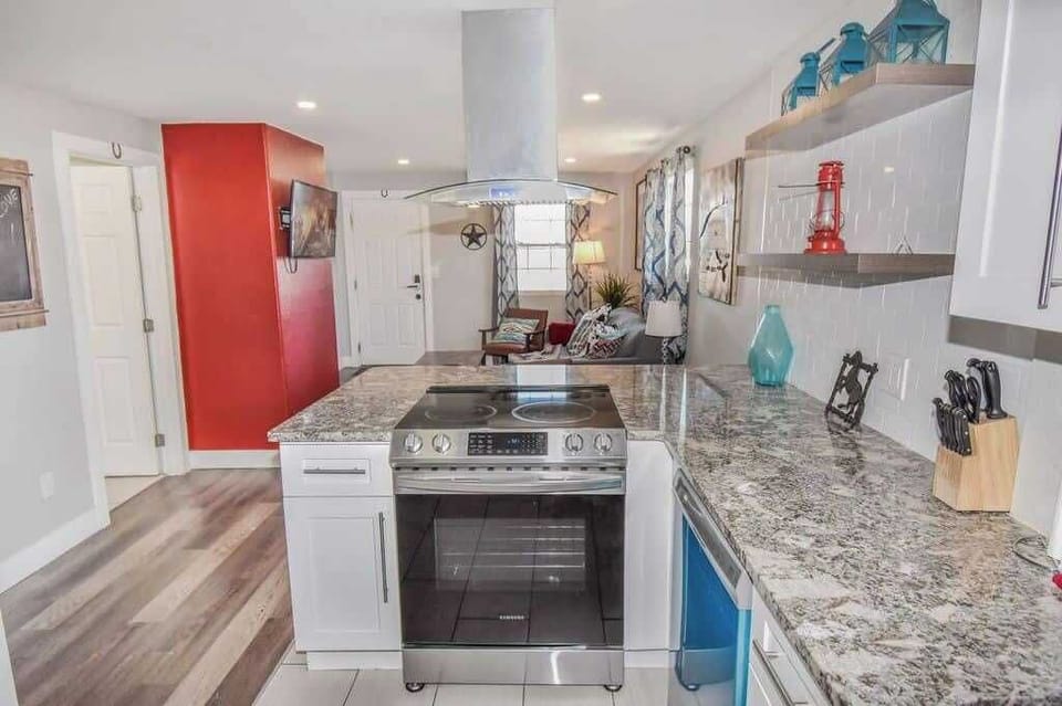 Modern appliances, cookware, and a dining area for home-cooked meals.