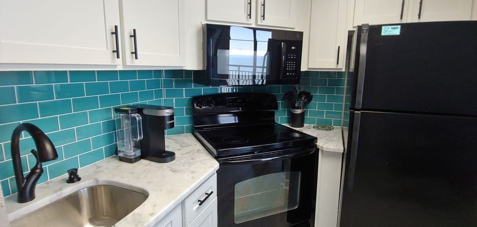 Ocean backsplash and Keurig coffee maker

