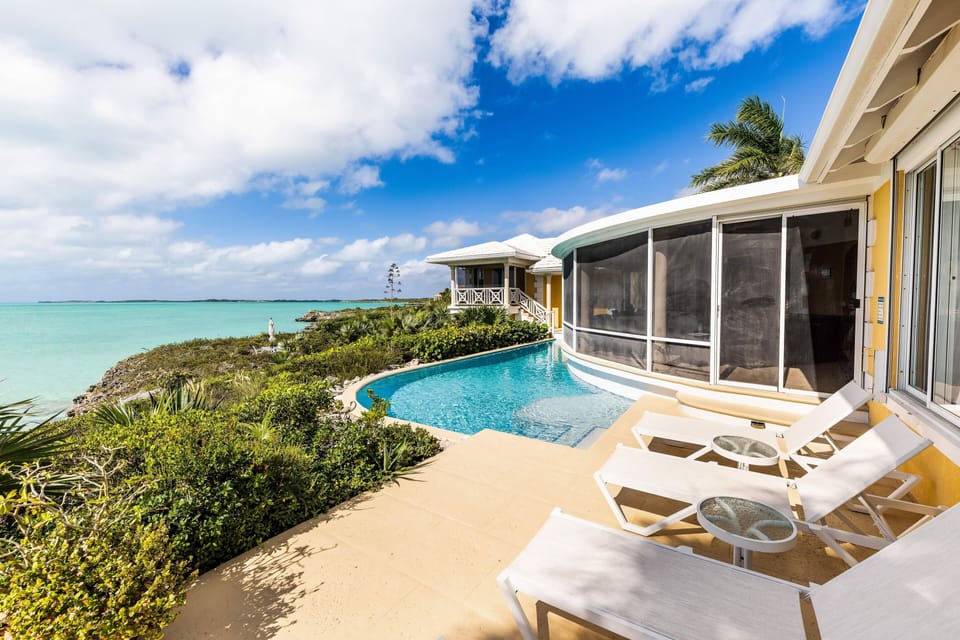 Sun loungers by the pool of the main house.