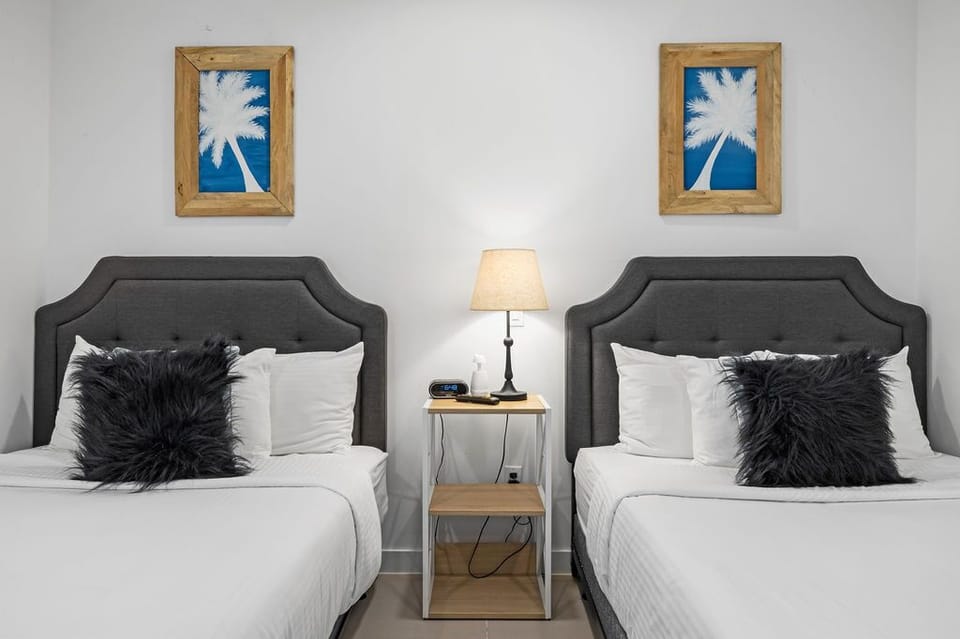 Sink into plush beds adorned with crisp linens and soft pillows. Coastal-inspired art and warm lighting create a serene, restful retreat for your stay.