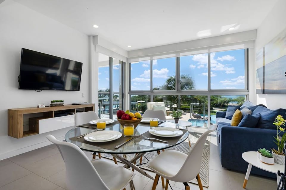 Step into your bright, open-concept living space where modern comfort meets stunning waterfront views. Relax on the plush sofa, dine with ocean breezes, and enjoy your private balcony paradise.