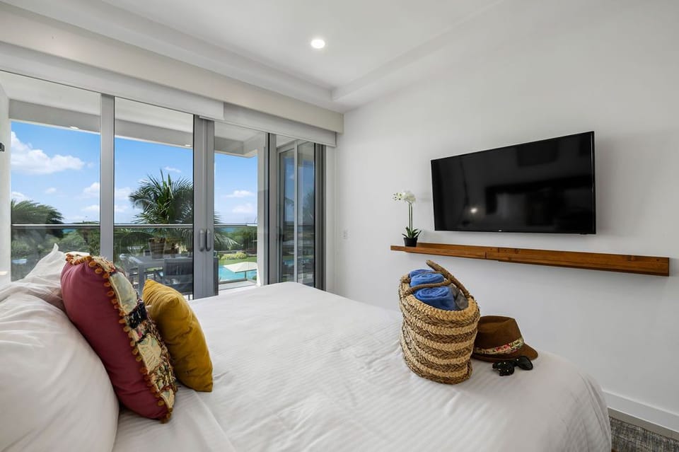 Wake to palm-framed sunshine, step onto your private balcony, and unwind beneath crisp linens with poolside views stretching beyond your terrace doors.