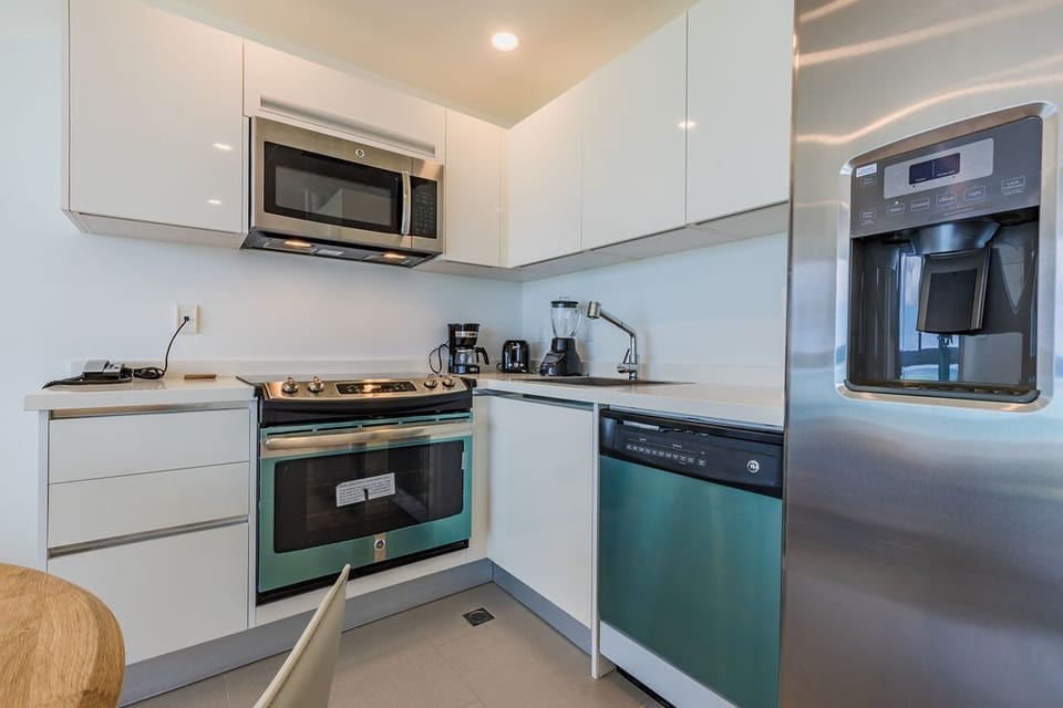 Your modern kitchen features sleek cabinetry, stainless steel appliances, and all the essentials to prepare meals just the way you like them—coffee maker, blender, and more.