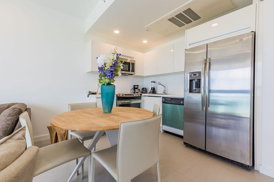 Your modern kitchen awaits with stainless steel appliances, sleek white cabinetry, and a cozy dining nook—perfect for preparing fresh breakfasts and gathering with loved ones.