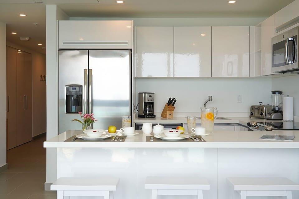 Modern, sleek kitchen awaits your culinary creations, with stainless appliances and a bright breakfast bar where you can savor your morning coffee while planning your day.