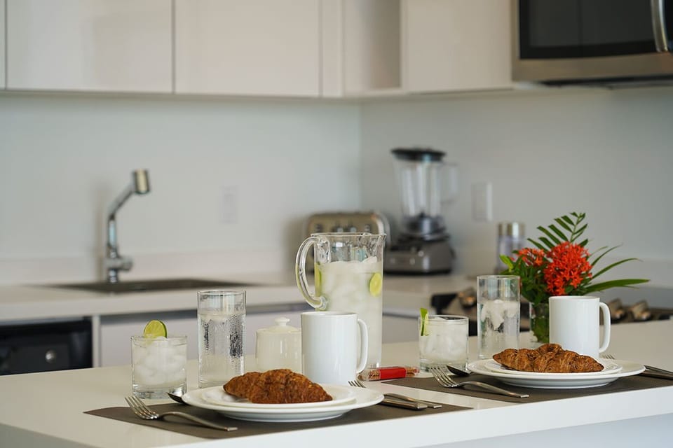 Start your mornings in your bright, modern kitchen with a fresh breakfast spread and refreshing drinks. The full appliances and spacious counter make meal prep effortless during your stay.