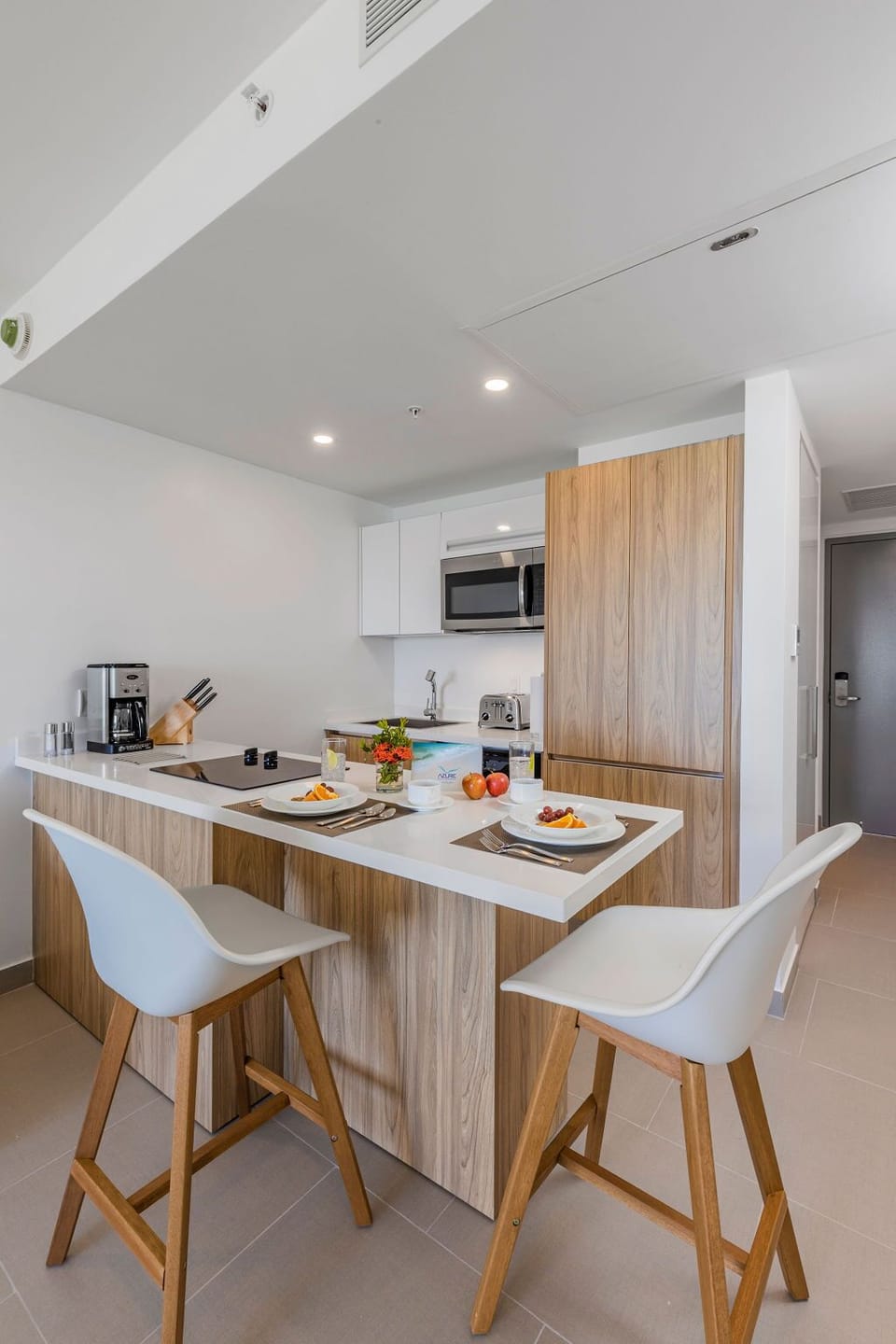 Your modern kitchen invites you to whip up a quick breakfast at the sleek counter, featuring wood-toned cabinetry, stainless steel appliances, and plenty of prep space for your morning coffee ritual.