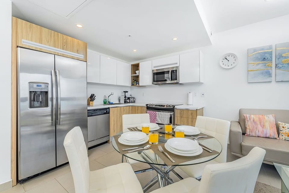 Step into a sun-lit open-concept space where you can cook, dine, and relax seamlessly. Stainless appliances, modern cabinetry, and a cozy seating nook create a welcoming retreat for your stay.