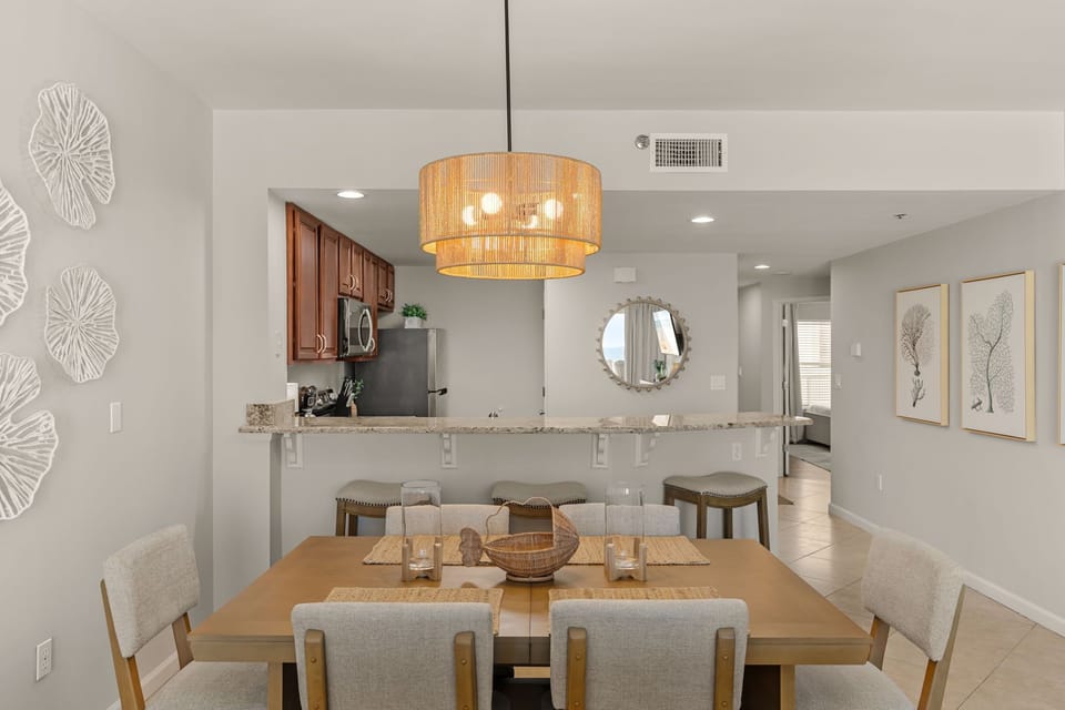 Your open-concept dining and kitchen space flows beautifully, where coastal elegance meets modern comfort for memorable meals together.