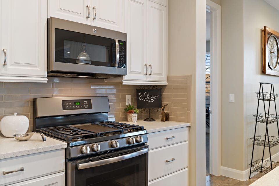 Fully stocked gourmet kitchen featuring all the comforts of home and extra seating at the bar