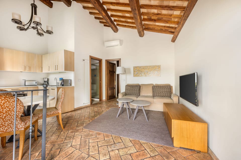 Relax in an open-plan living space that pairs traditional beams with contemporary furnishings.