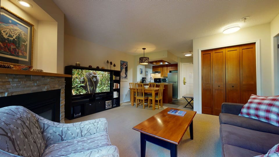 Living and kitchen area with 60" TV