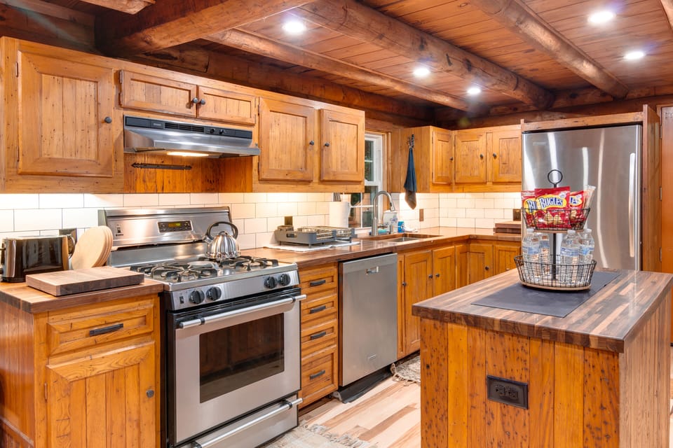 Full kitchen equipped with pots/pans/dishes.