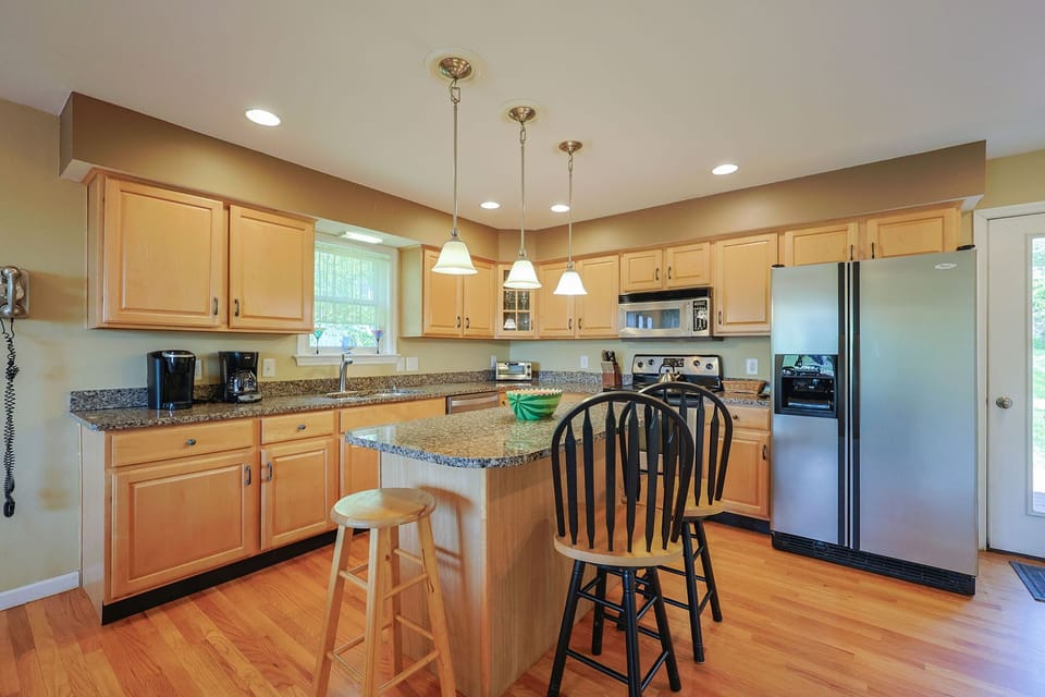 A fully-applianced eat-in kitchen with center island.