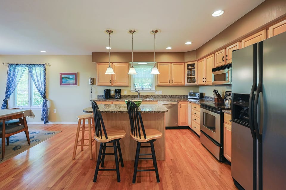 Warm wood cabinets and modern appliances complete the kitchen.