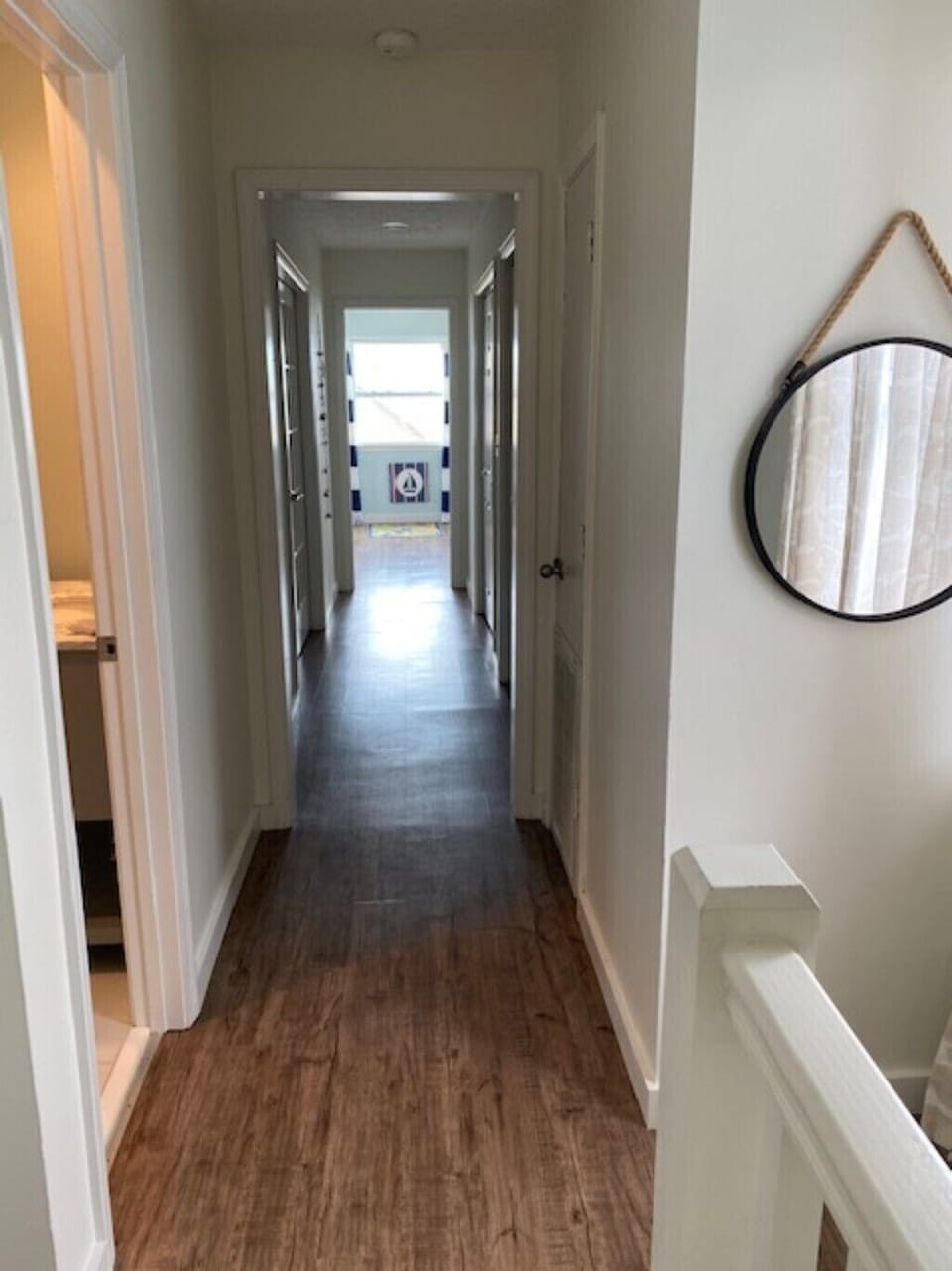 Upstairs looking down the second floor hallway, bathroom first door on left.